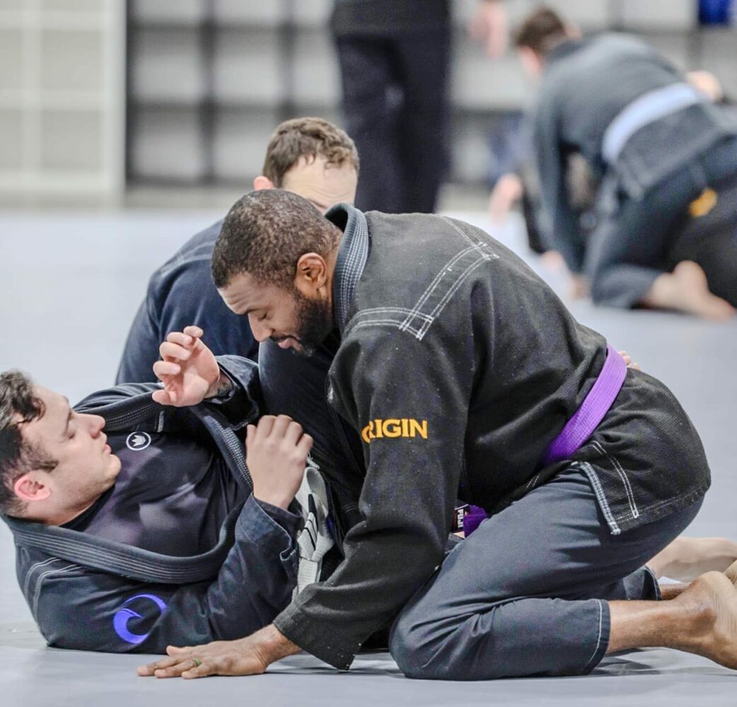 Adults practicing control in jiu jitsu